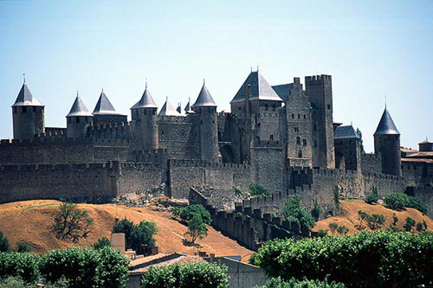This is a fortified city or citadel of Carcassonne in inland southern France, I visited in my teens. Few citadels like this remain in Europe, if they were important, cannons demolished them. Carcassonne evaded this fate because a treaty in the 1600's made it a part of France, no longer a city/state, and its borders were moved hundreds of miles away. Image: France This Way