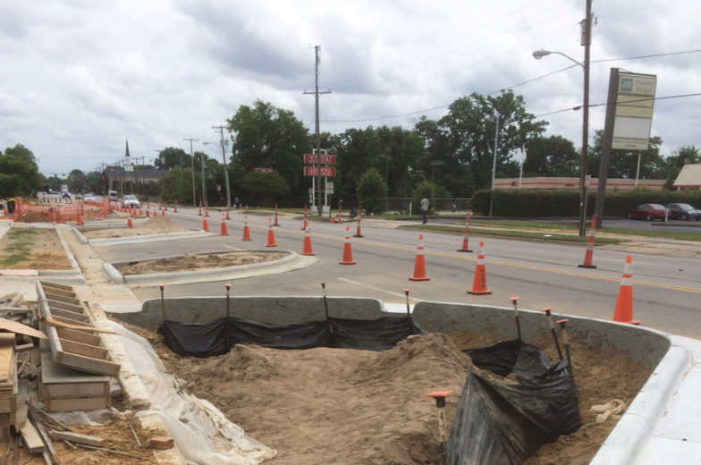 Staging and traffic controls for construction of the north side of the green street while keeping the south side open and available to vehicular and pedestrian traffic.