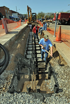 Workers for Bruce Construction from Plum install Silva cells along Colombia Avenue in Vandergrift.